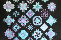 2015-2016 Alternate colorway for Quilters Common BOMPersonally Hand-Dyed fabrics, blocks scaled from 12" to 6"and 13 additional blocks added.  Custom quilted